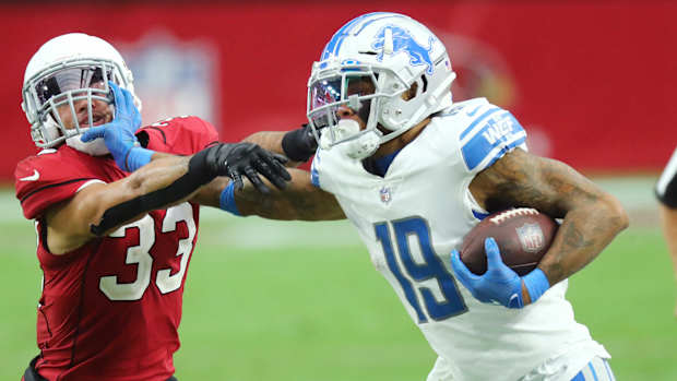Lions receiver Kenny Golladay stiff-arms a defender during a win over the Cardinals